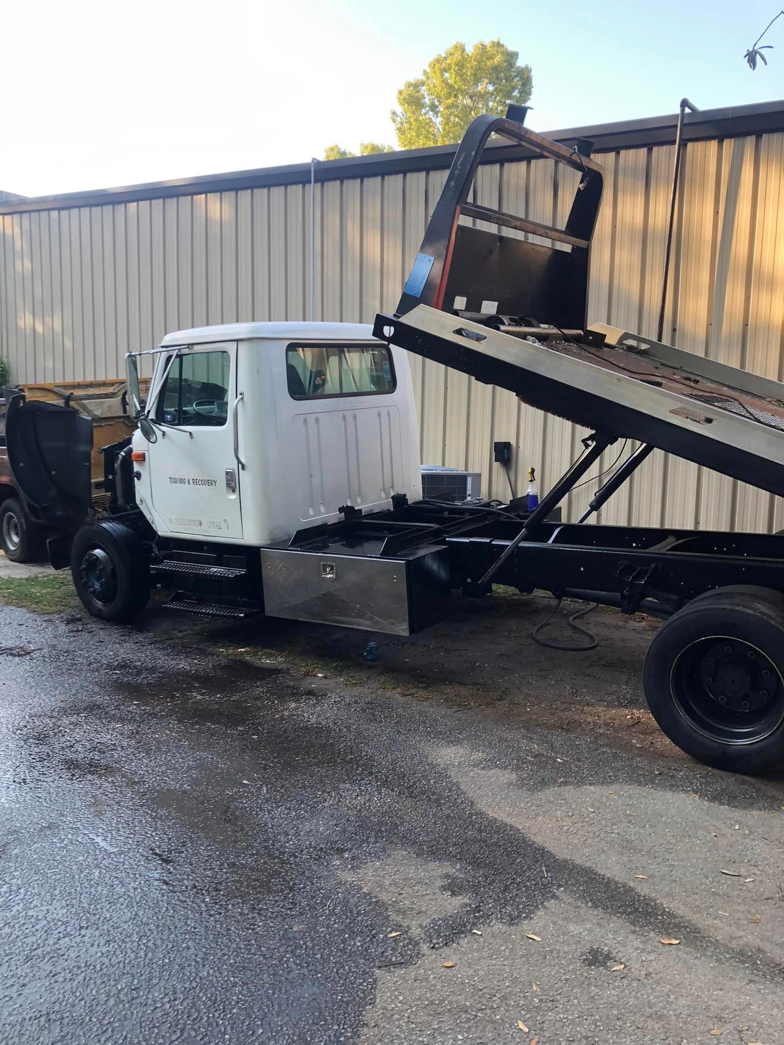 Red and white flatbed with ramps deployed