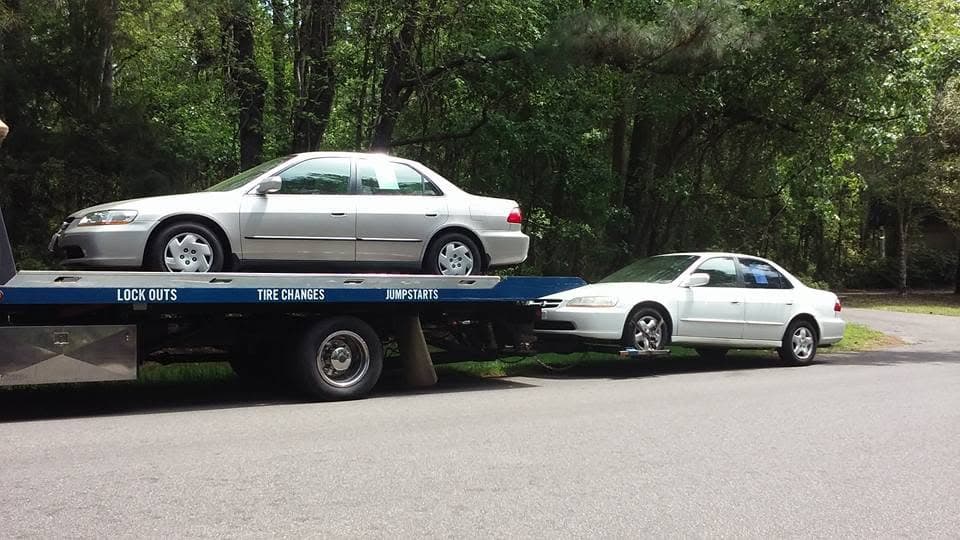Flatbed carrying a silver Honda Accord