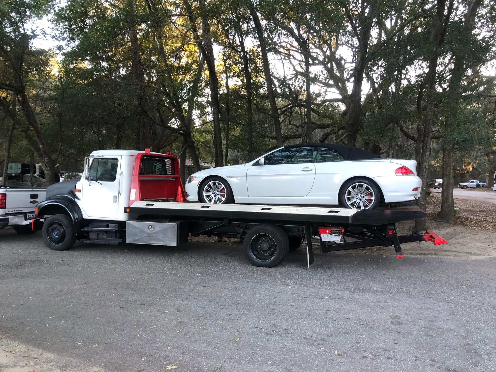 Tow truck with Signature Catering box truck