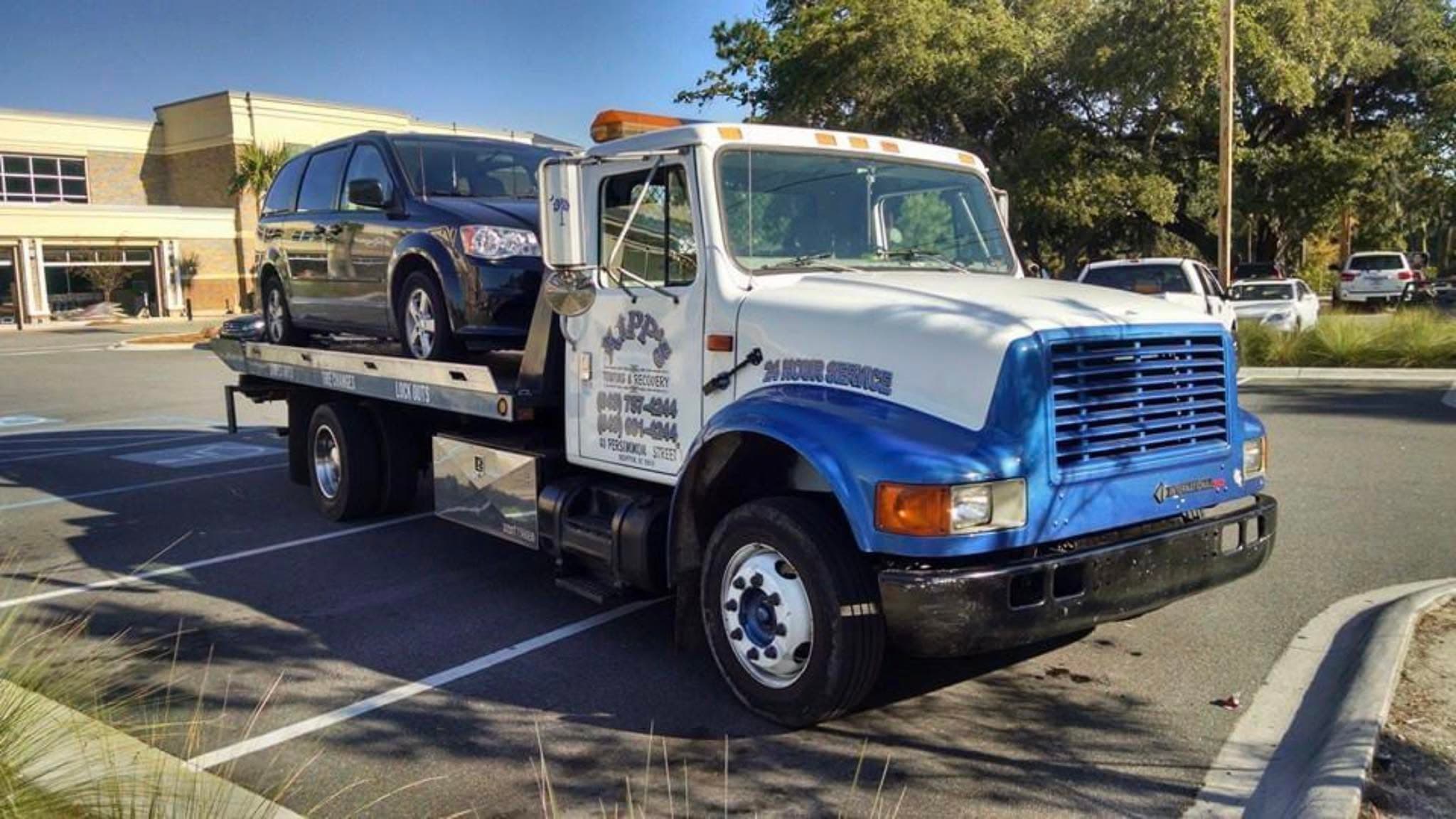 Towing an American Tile & Stone utility truck
