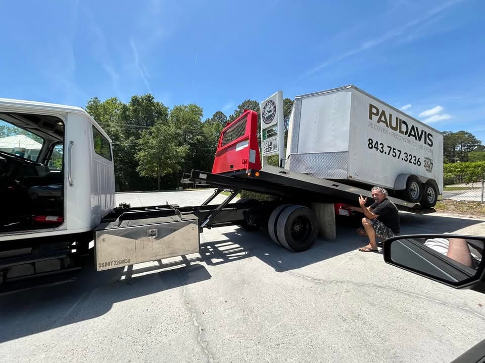 Gray Dodge Durango being loaded onto flatbed