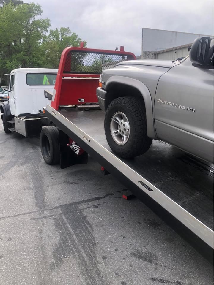 Tow truck on wet road with job in progress